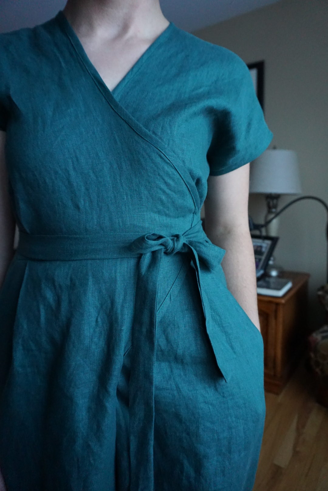 A close-up of the bodice of Megan's jumpsuit, showing the ties and the wrap overlap.